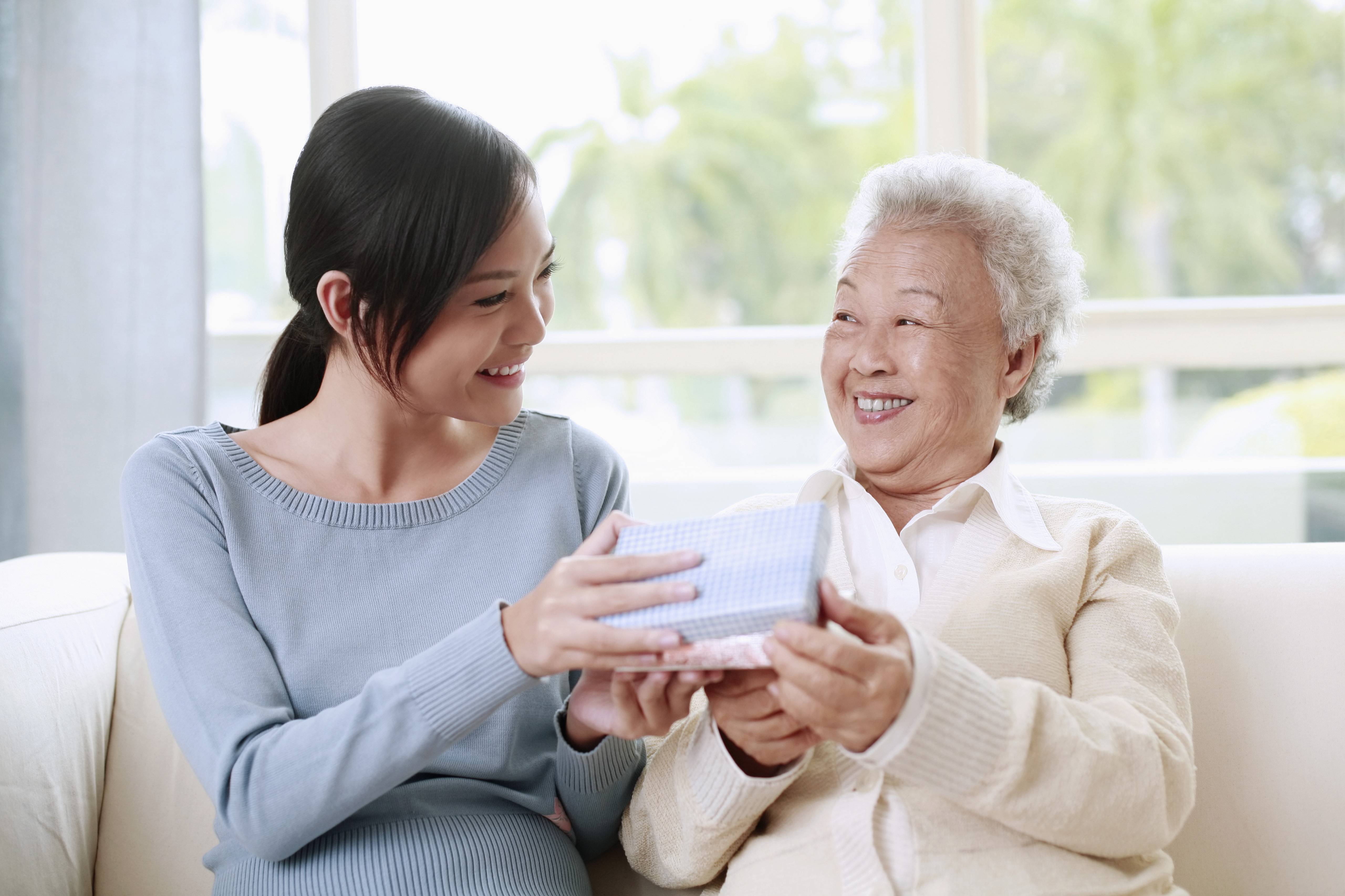 Woman giving senior woman