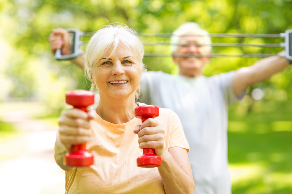 Senior Couple Exercising In Park